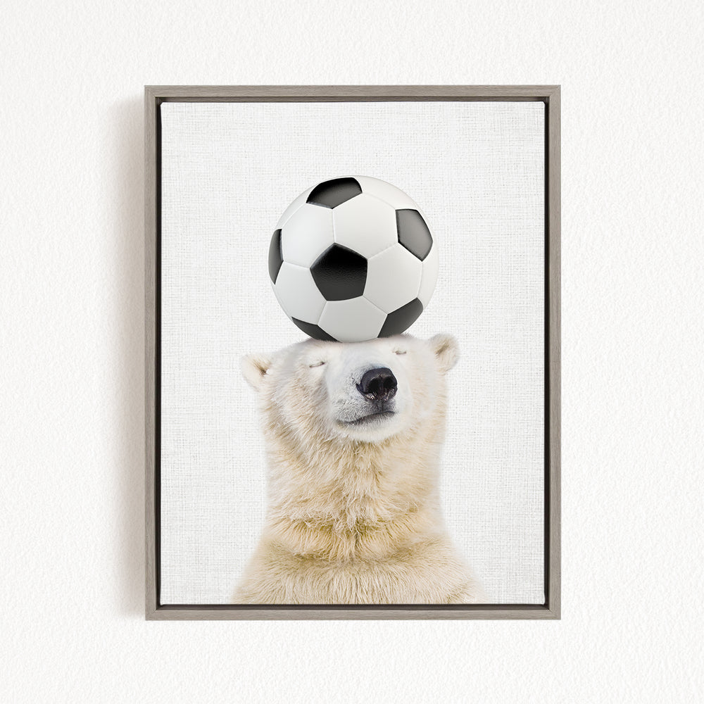 A polar bear balancing a soccer ball on its head.