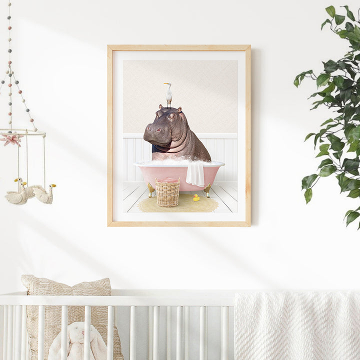 A framed image of a hippopotamus sitting in a pink bathtub, surrounded by various objects such as a basket, a stuffed animal, and a stuffed bird.