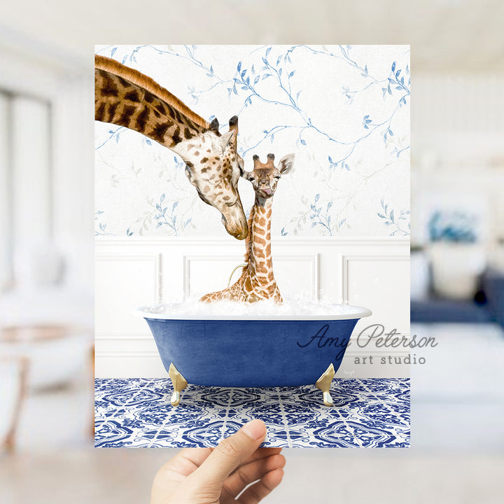 a hand holding a card with a picture of two giraffes in a