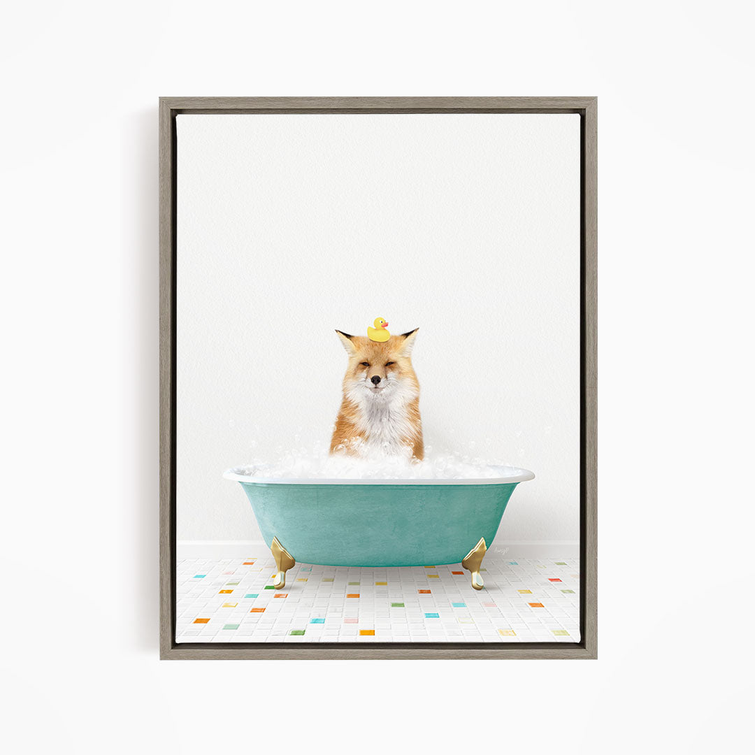 A fox is sitting in a green bathtub filled with bubbles, with a rubber duck perched on its head.