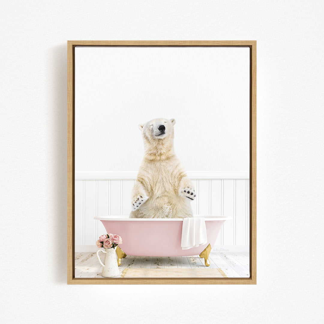 A polar bear standing in a pink bathtub, with a vase of flowers and a towel nearby.