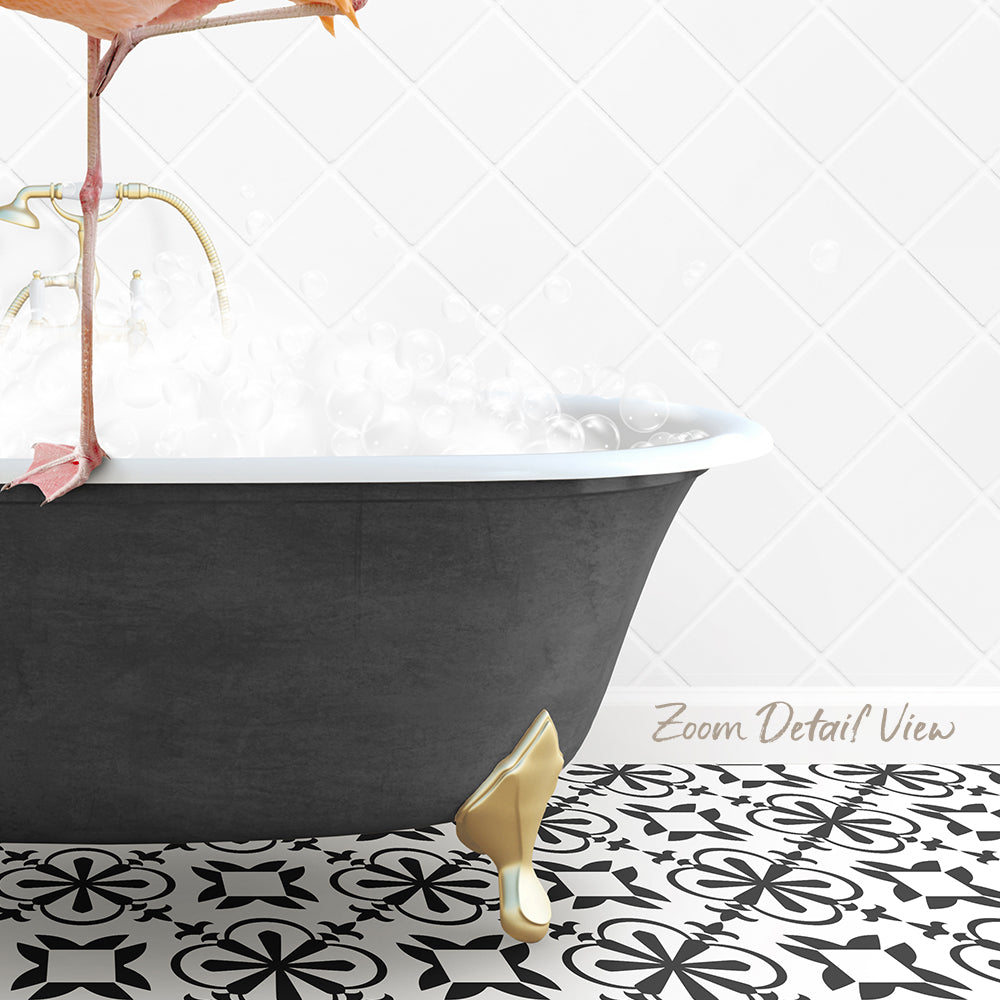 A black claw-foot bathtub filled with water, with a gold faucet and a pink flamingo perched on the edge of the tub.