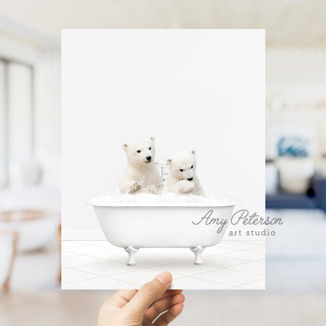 a person holding up a card with two small white dogs in a bathtub