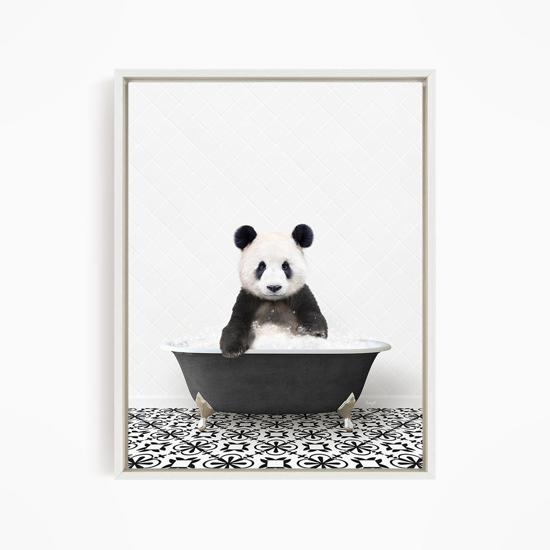 A panda bear sitting in a bathtub filled with bubbles, surrounded by a black and white patterned floor.