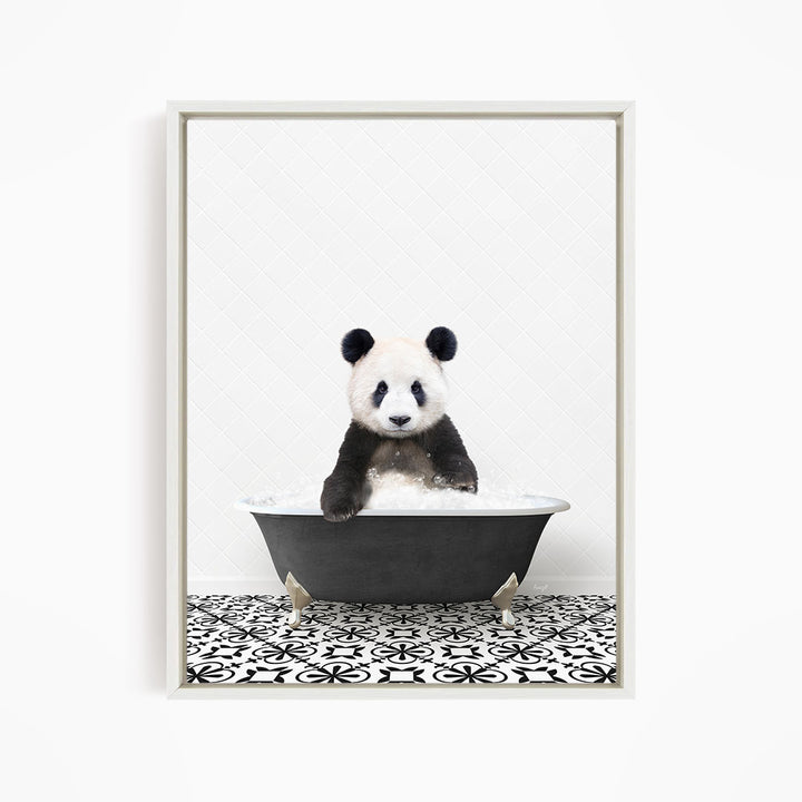 A panda bear sitting in a bathtub filled with bubbles, surrounded by a black and white patterned floor.