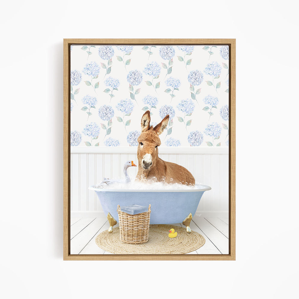 A donkey is sitting in a blue bathtub filled with bubbles, surrounded by rubber ducks and a basket.