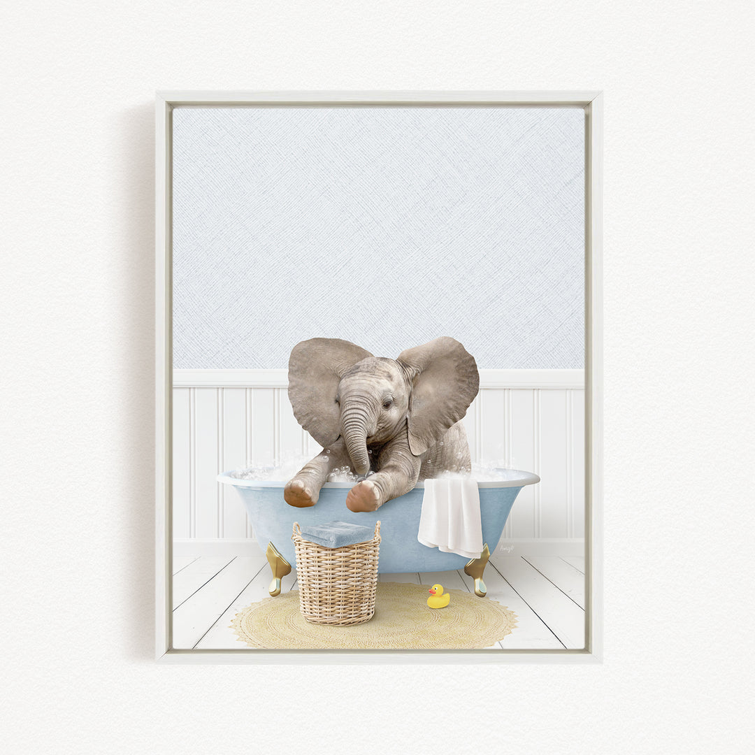 A baby elephant sitting in a bathtub filled with water, surrounded by a basket of toys and a yellow rubber duck.