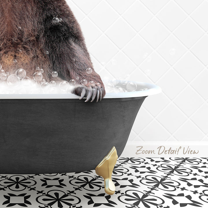A close-up of a bear's paw resting on the edge of a bathtub filled with bubbles, with a gold bathtub faucet and a patterned tile floor visible in the background.