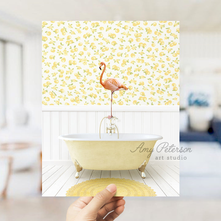 a person holding up a picture of a flamingo in a bathtub