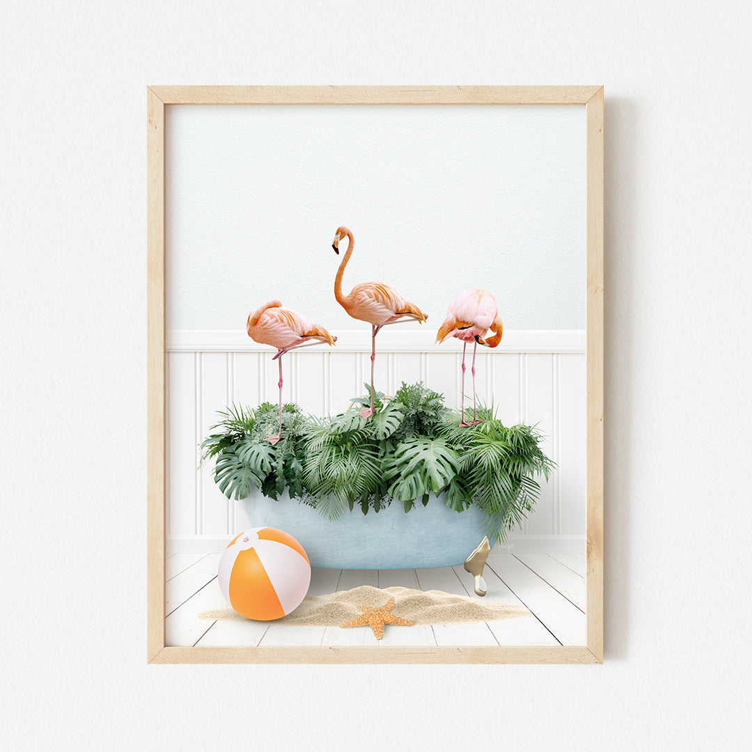 a group of flamingos in a planter with a beach ball