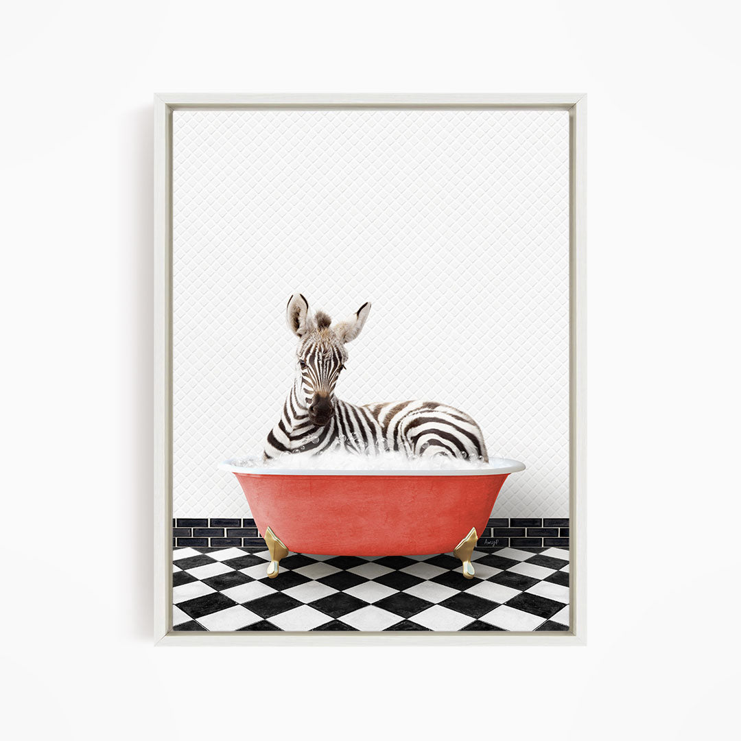 A zebra is sitting in a red bathtub on a black and white checkered floor.