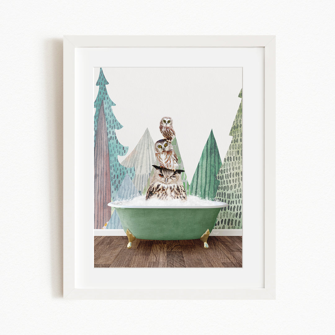 A framed print depicting a whimsical scene of an owl perched on a green bathtub, surrounded by stylized trees and a snowy landscape.