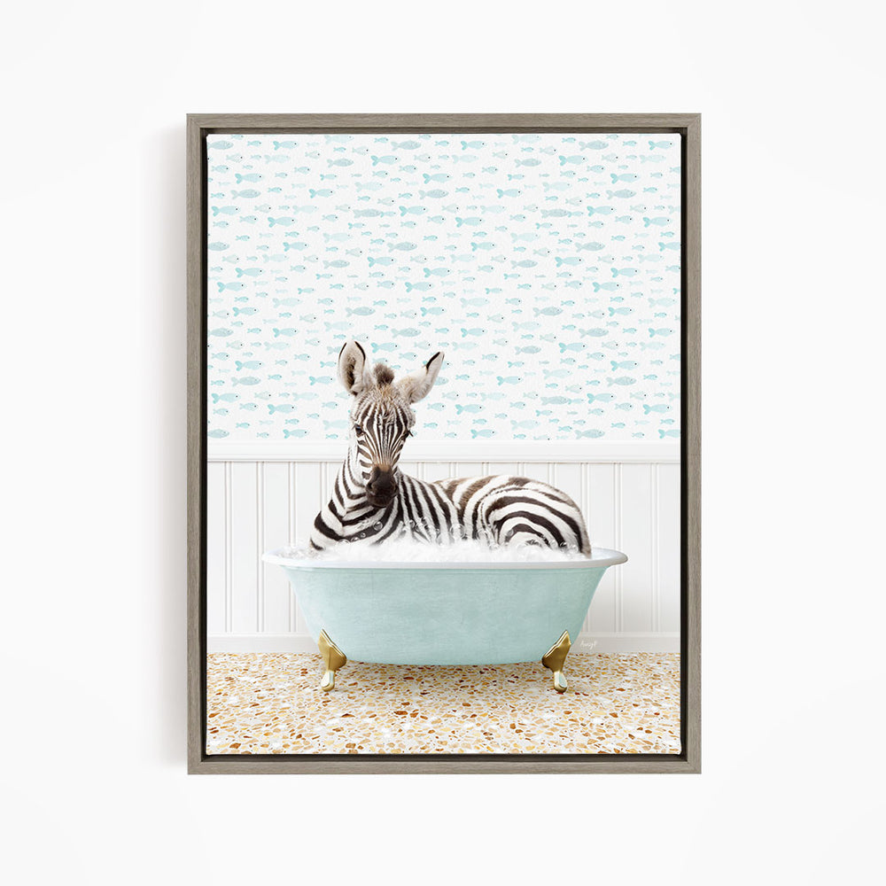 A zebra is sitting in a light blue bathtub, surrounded by a pattern of small fish.