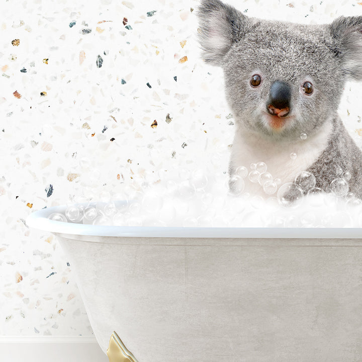 a koala is sitting in a bathtub with bubbles