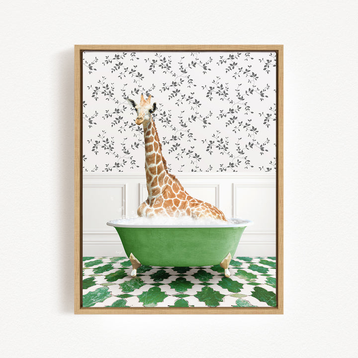 A giraffe is sitting in a green bathtub, surrounded by a patterned tile floor and a floral wallpaper background.