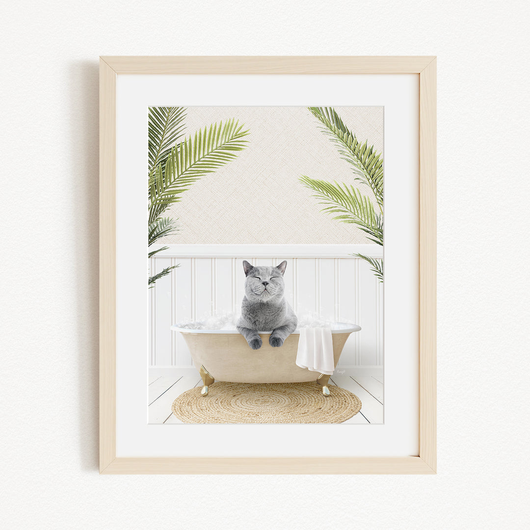 A gray cat sitting in a white bathtub, surrounded by green plants, creating a serene and relaxing atmosphere.