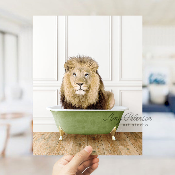 a lion sitting in a bathtub with a hand holding it