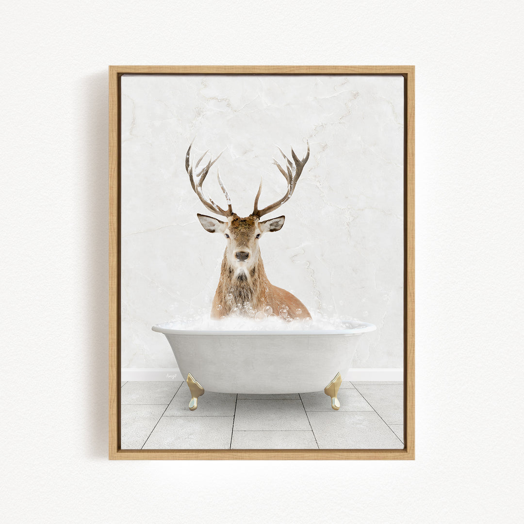 A deer with large antlers is sitting in a white bathtub filled with water, creating a whimsical and unexpected scene.