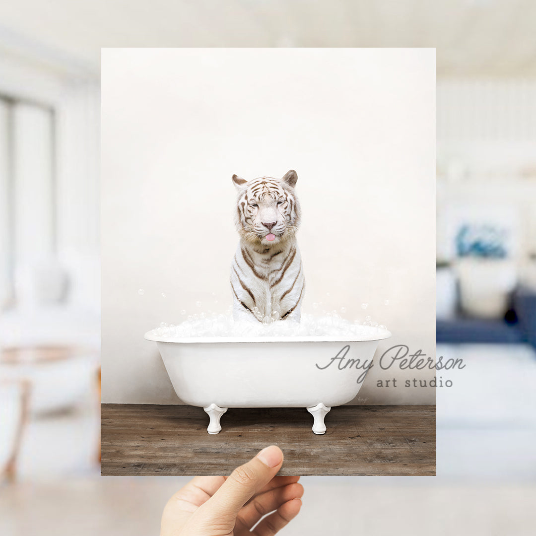 a white tiger sitting on top of a bath tub