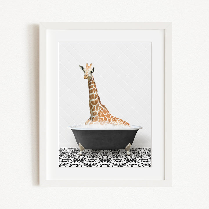A giraffe is sitting in a black bathtub filled with water, creating a whimsical and playful scene.