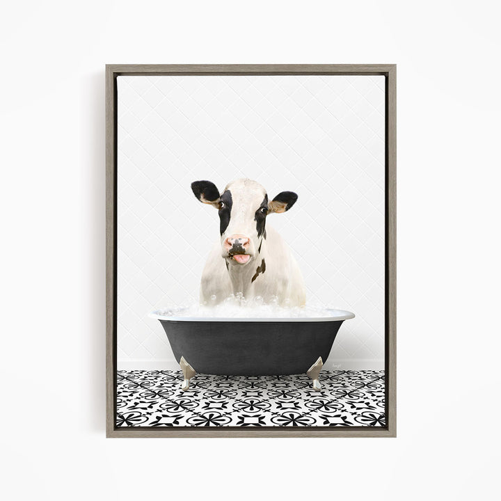 A black and white cow is sitting in a black bathtub filled with water, creating a whimsical and humorous scene.
