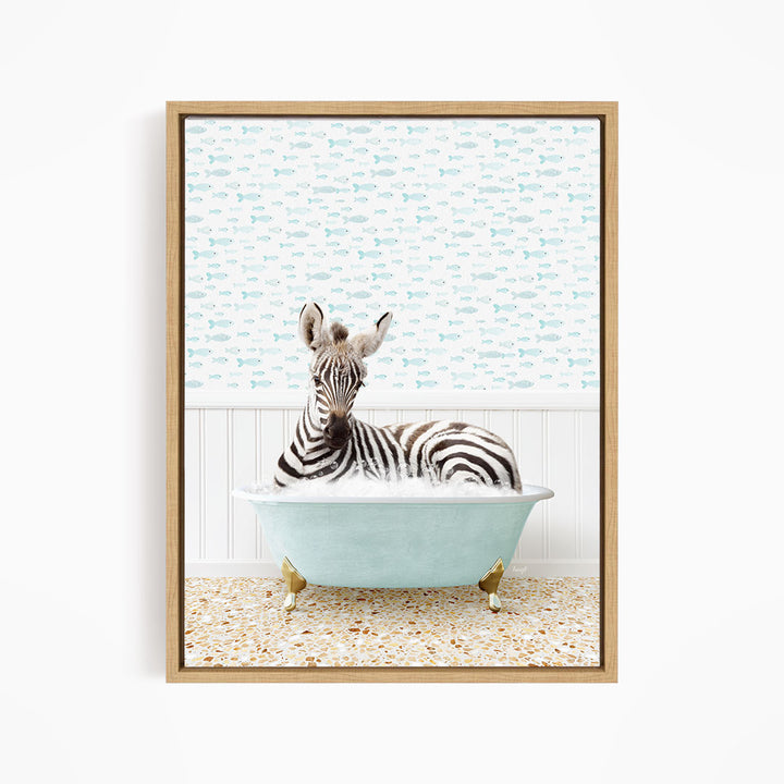 A zebra is sitting in a light blue bathtub, surrounded by a pattern of small fish on the wall behind it.