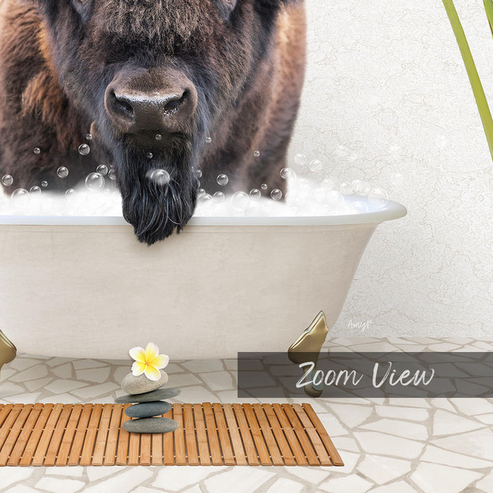 A bison is taking a bath in a white bathtub, surrounded by bubbles, with a yellow flower and stones nearby.