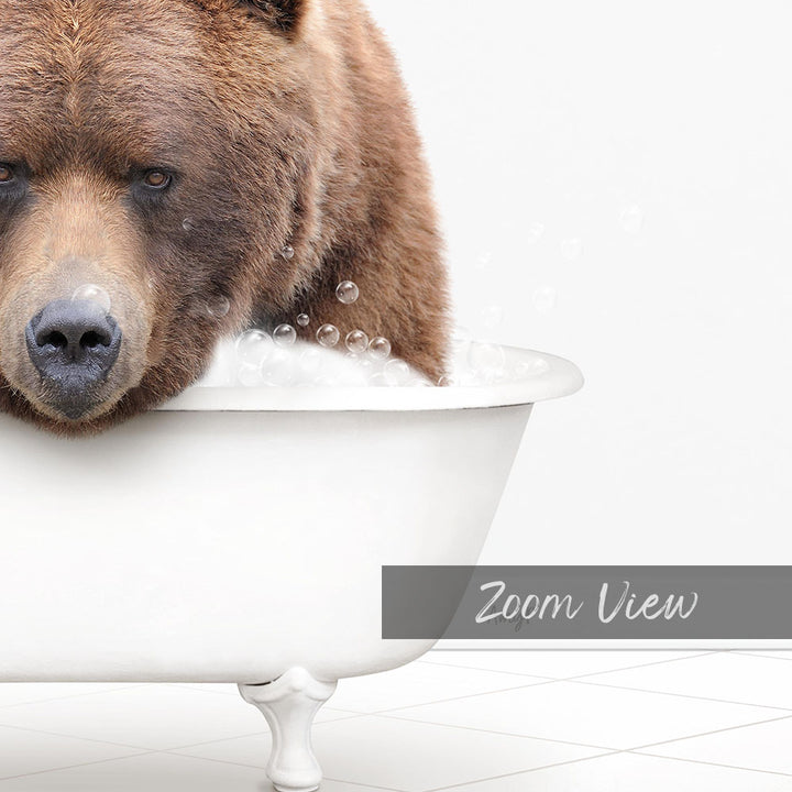 A brown bear is sitting in a white bathtub filled with bubbles, creating a whimsical and playful scene.