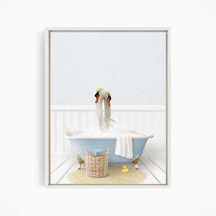 A white swan is sitting in a blue bathtub filled with bubbles, with a yellow rubber duck nearby.
