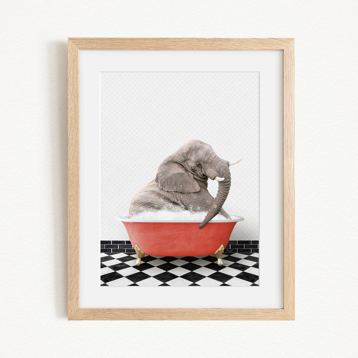 A gray elephant is sitting in a red bathtub on a black and white checkered floor.