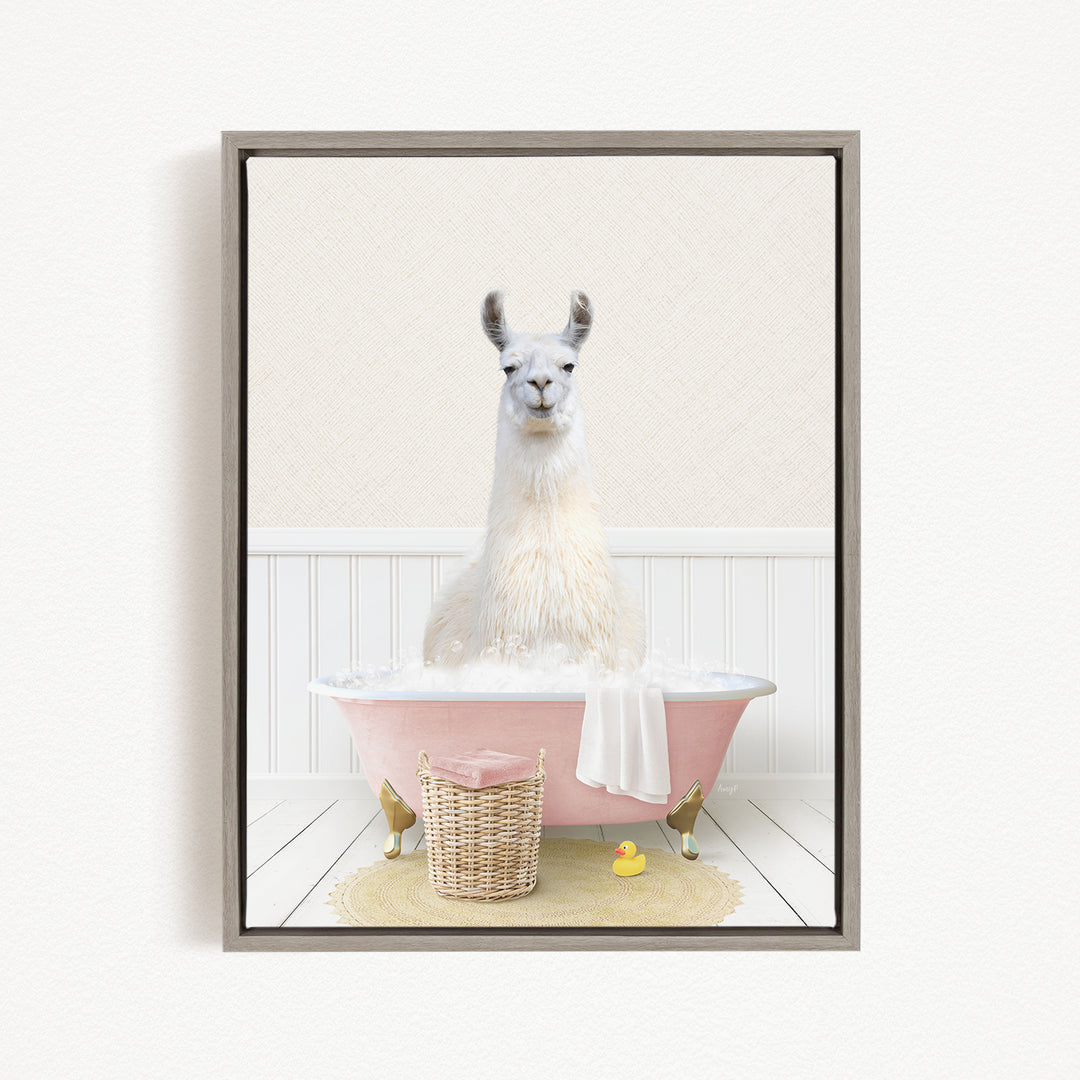 A white llama sitting in a pink bathtub filled with water, surrounded by a yellow rubber duck and a wicker basket.