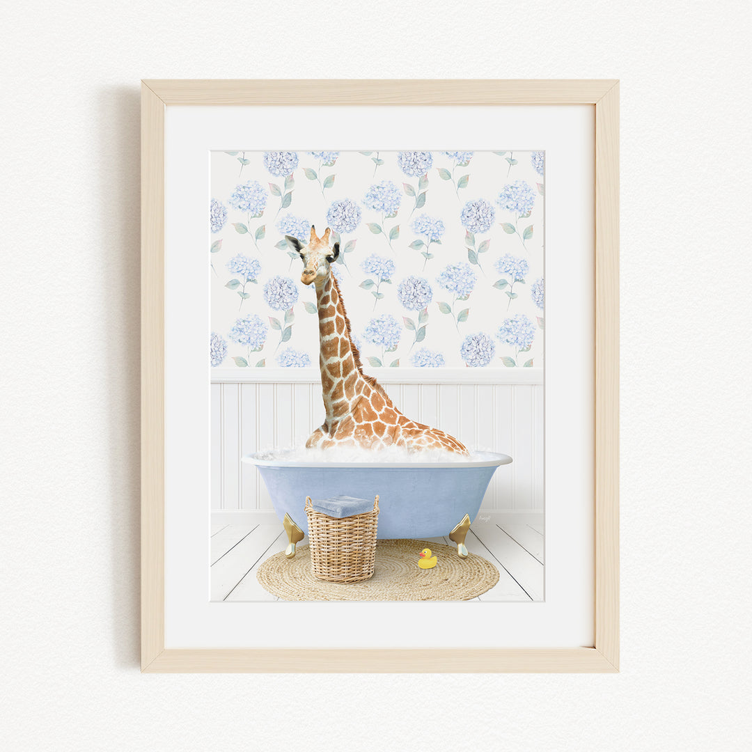 A giraffe sitting in a blue bathtub filled with water, surrounded by a floral patterned wall and a basket of rubber ducks.