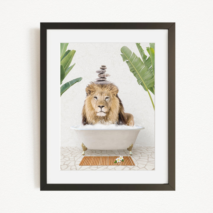 A framed image depicting a lion sitting in a bathtub filled with water, surrounded by tropical plants.