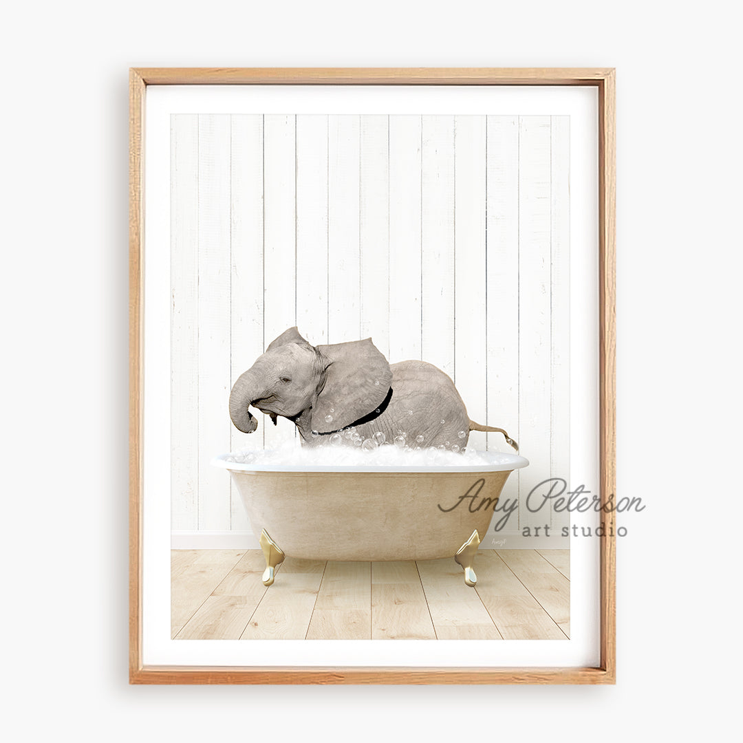 a framed picture of an elephant taking a bath