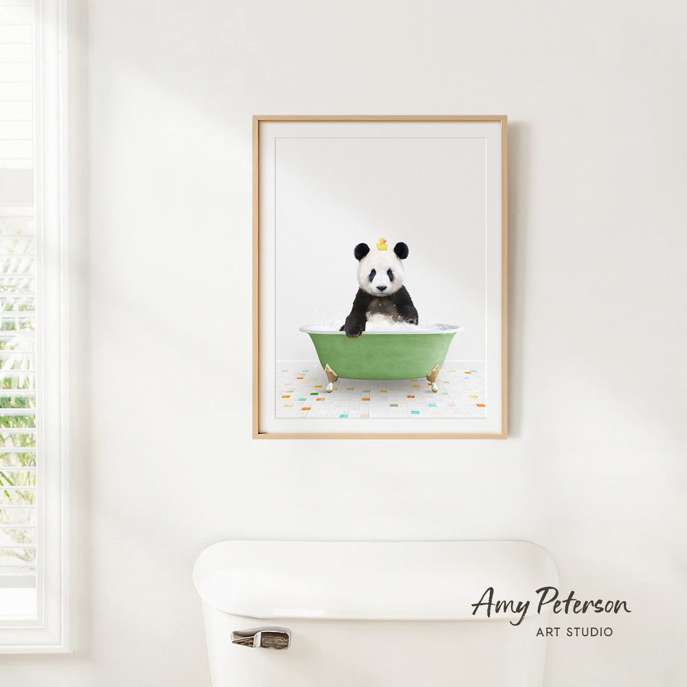 A framed image of a panda sitting in a green bathtub, with colorful tiles on the floor.