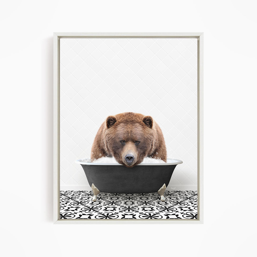 A brown bear is sitting in a bathtub filled with water, appearing to be enjoying the bath.