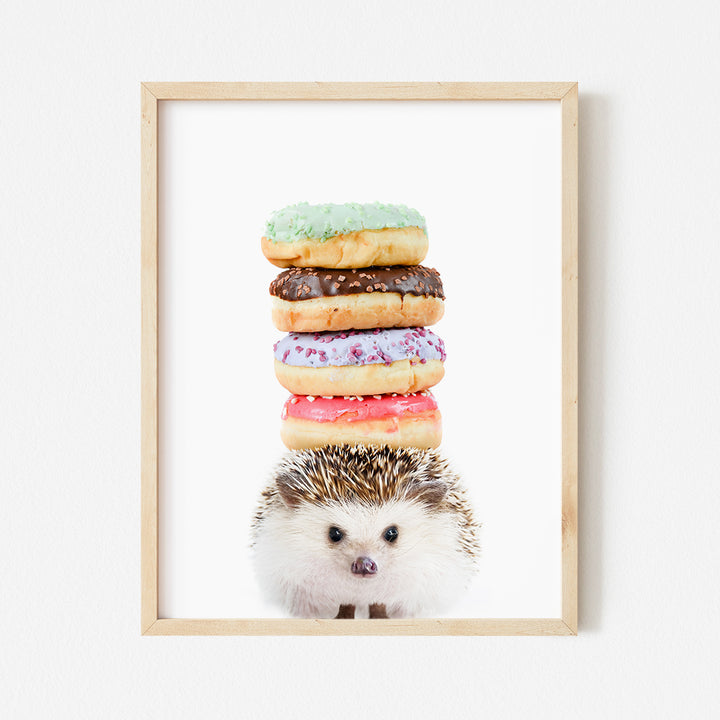 a hedgehog sitting in front of a stack of donuts