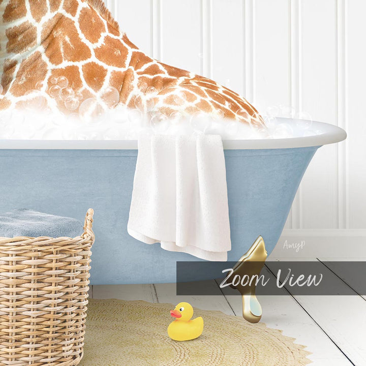 A giraffe is sitting in a blue bathtub filled with bubbles, surrounded by a wicker basket, a yellow rubber duck, and a towel.