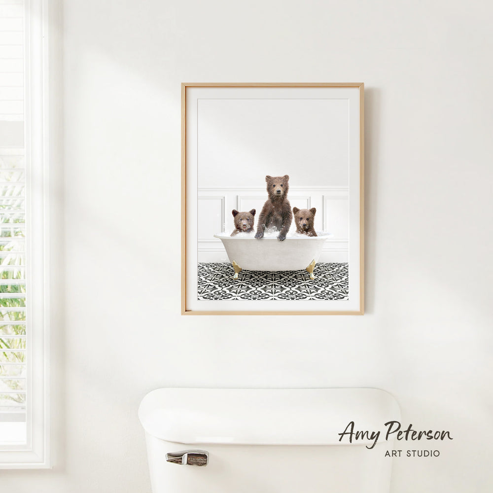 A framed image of three bears sitting in a bathtub, with one bear sitting in the center and the other two bears sitting on either side.