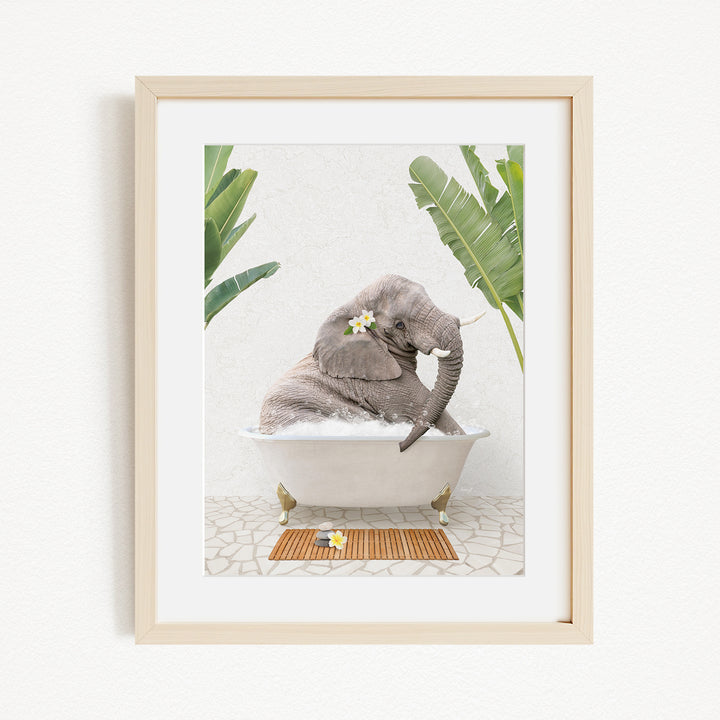 A gray elephant is sitting in a white bathtub, surrounded by green leaves and flowers, creating a whimsical and serene scene.