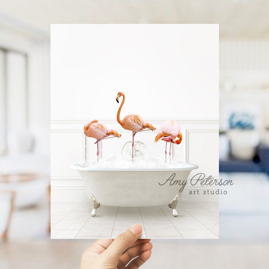 a person holding up a card with flamingos in a bathtub