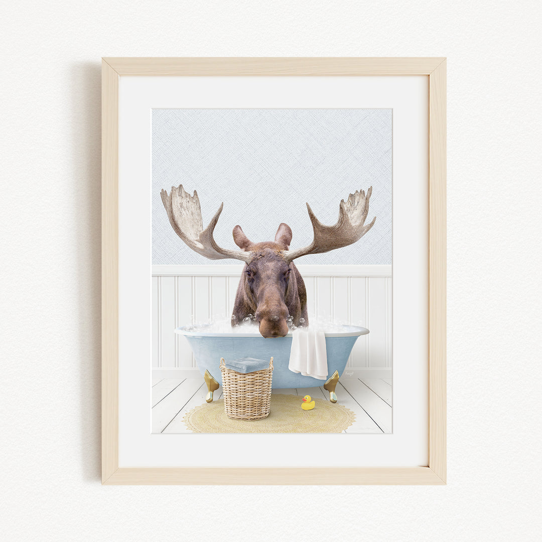 A moose with large antlers is sitting in a bathtub filled with water, surrounded by rubber ducks.