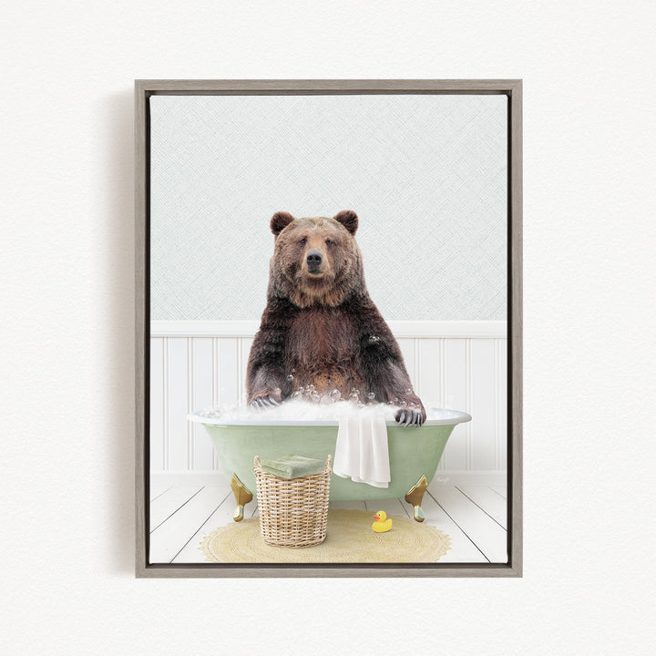 A brown bear sitting in a green bathtub filled with water, surrounded by a yellow rubber duck and a basket.