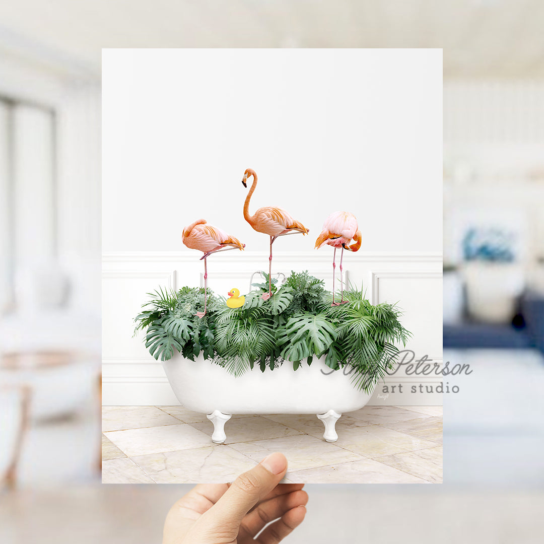 a hand holding up a card with three flamingos in a bathtub