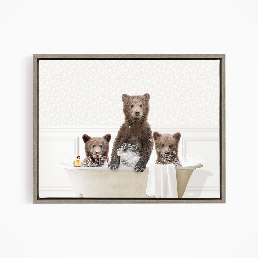 A framed image depicting three bears sitting in a bathtub, with one bear sitting on the edge of the tub and the other two bears sitting inside the tub.