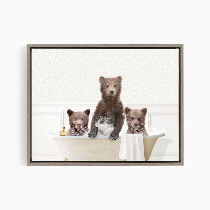 A framed image depicting three bears sitting in a bathtub, with one bear sitting on the edge of the tub and the other two bears sitting inside the tub.