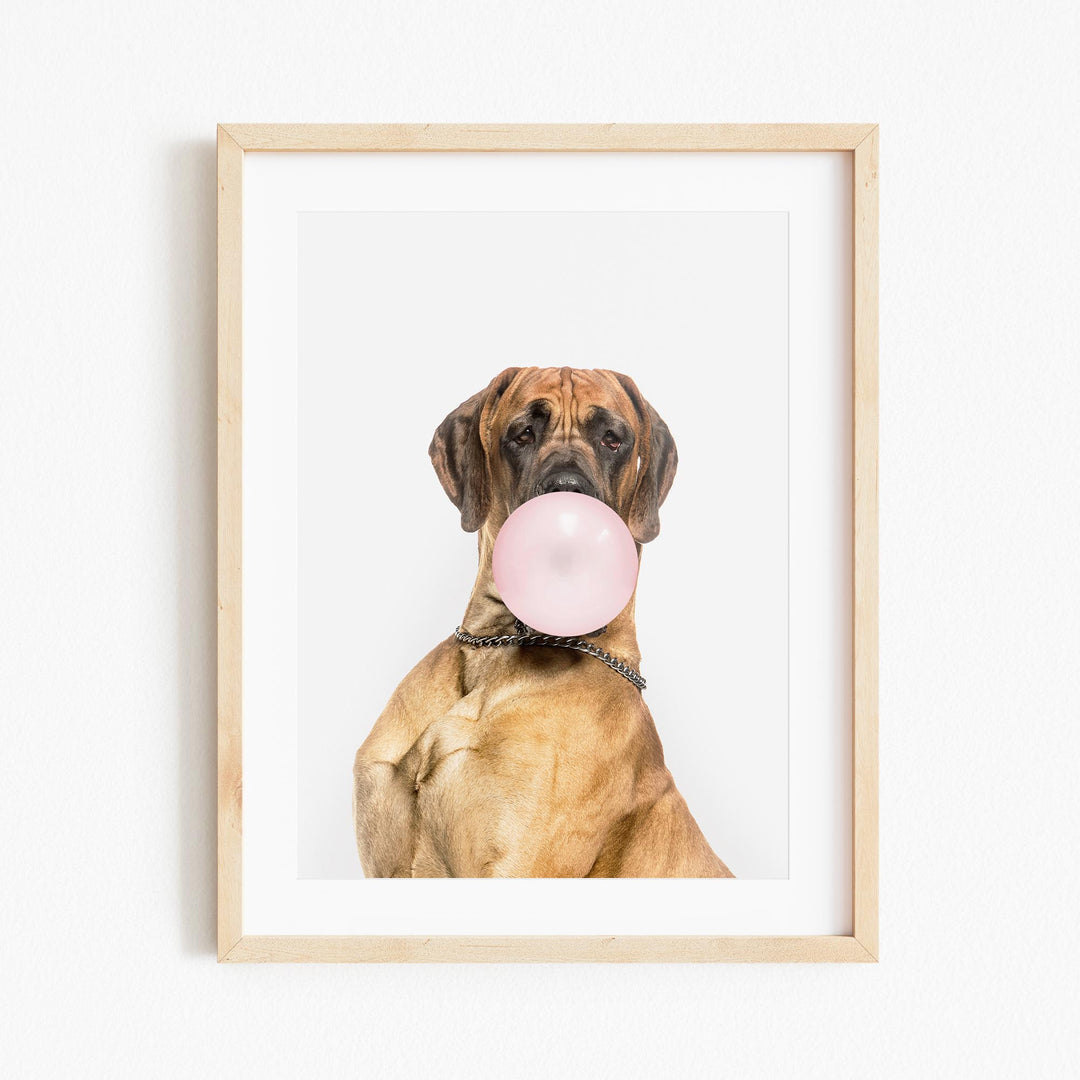 a picture of a dog with a pink bubble in it's mouth