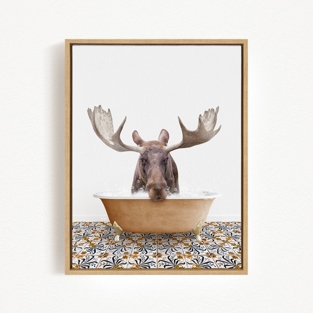 A moose with large antlers is sitting in a bathtub filled with water, creating a whimsical and humorous scene.