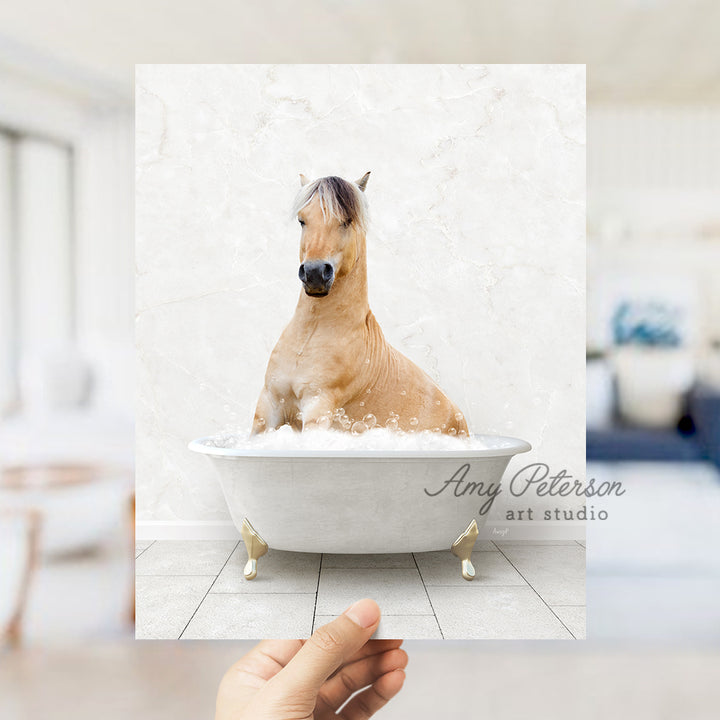 a hand holding a photo of a horse in a bathtub