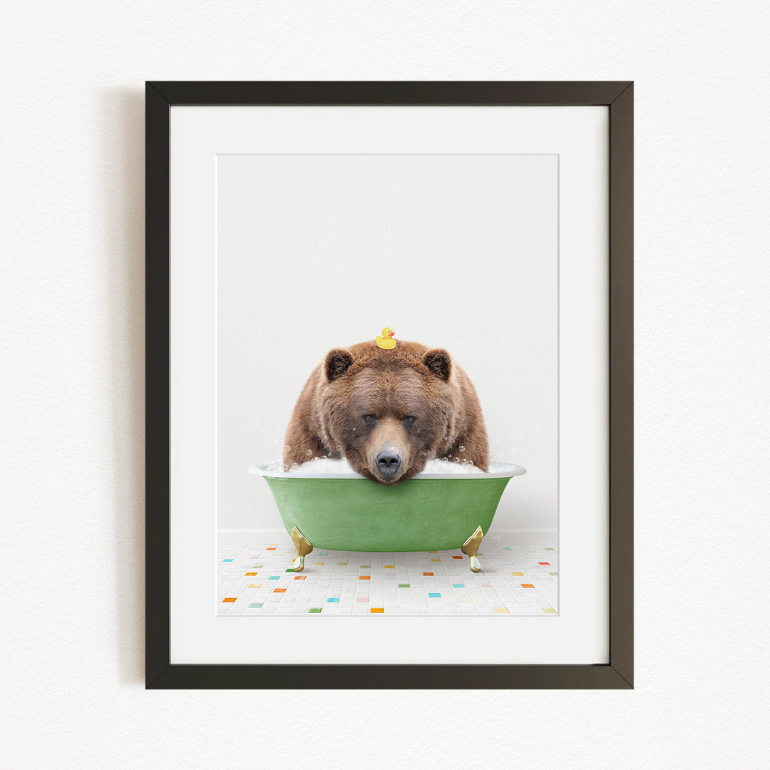 A brown bear is sitting in a green bathtub filled with water, surrounded by rubber ducks.